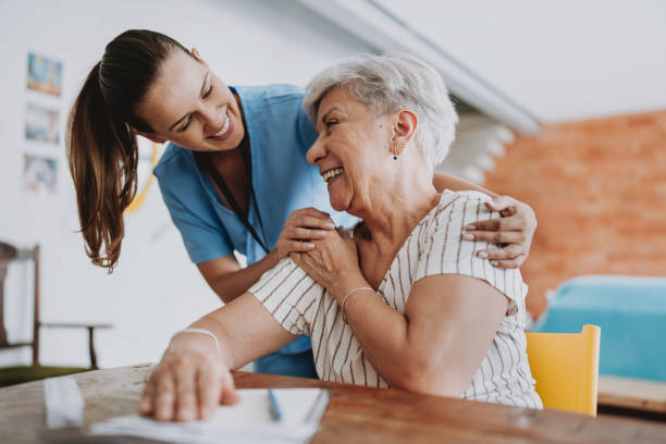 Home care healthcare professional hugging senior patient